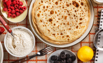 Pandekager – måske det mest alsidige mad i verden Pandekager paa bord med friske baer og sukker